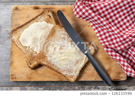 Sliced fresh bread and butter on wooden table Sliced fresh bread and butter on wooden table 126133599