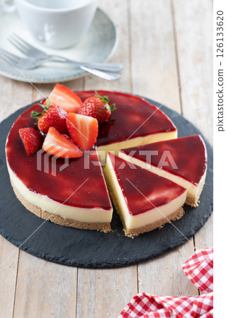 Cheesecake with strawberries on wooden table 126133620