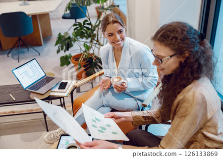 Women professionals collaborating effectively in a modern, dynamic workspace environment Women professionals collaborating effectively in a modern, dynamic workspace environment 126133869