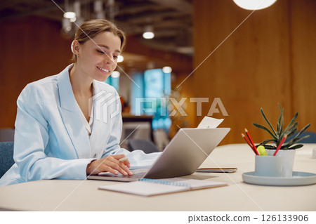 A Professional Woman Engaged in Her Work within a Stylish and Modern Office Environment 126133906