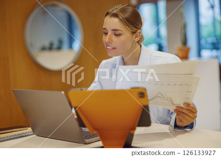 Dedicated Professional Expert Engaged in Analyzing Data Within a Contemporary Workspace Environment 126133927