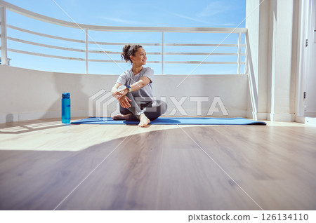 Young Woman Practicing Yoga Outdoors on a Sunny Day in a Relaxing Setting 126134110
