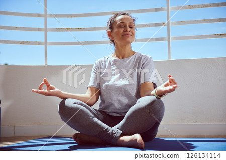 Woman Practicing Meditation Outdoors in Relaxed Setting for Mindful Wellness 126134114