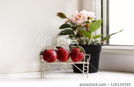 Strawberries on a small vintage bench. Beauty and food design 126134585