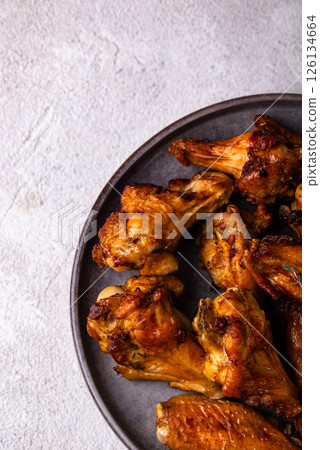 Baked spicy chicken wings with sauce 126134664