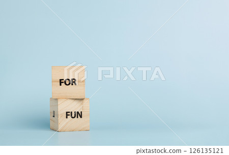 Wooden cubes with inscriptions For Fun on a blue background 126135121