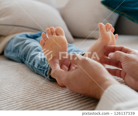 baby feet, boy feet, foot massage, dad tickles son's feet, foot tickling . High quality photo baby feet, boy feet, foot massage, dad tickles son's feet, foot tickling . High quality photo 126137339