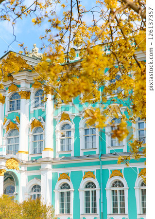 the incredibly picturesque facade of the Winter Palace through the branches of trees on a clear spring day, the heritage of Russia, the most famous landmark of St. Petersburg, the museum the incredibly picturesque facade of the Winter Palace through the branches of trees on a clear spring day, the heritage of Russia, the most famous landmark of St. Petersburg, the museum 126137357