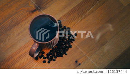 Steaming coffee mug on wooden tabletop, coffee filling frame with rich aroma, coffee invoking warm morning ritual, clip for beverage ads, cafe branding lifestyle inspiration, social content worldwide 126137444