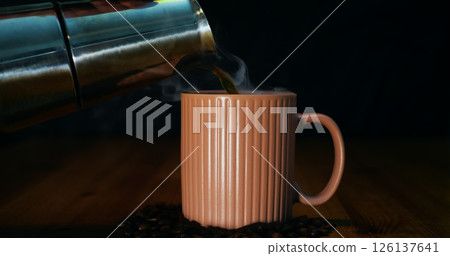 Moka pot pouring hot coffee into ridged mug, coffee infusing air with rich aroma and depth coffee delivering bold flavor and cozy warmth, coffee perfect for specialty beverage and lifestyle promotions 126137641