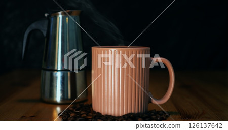 Geyser coffee maker beside filled mug, geyser coffee maker highlighting authentic brew technique, geyser coffee maker embodying artisan ritual, ideal for home barista and cafe marketing. 126137642