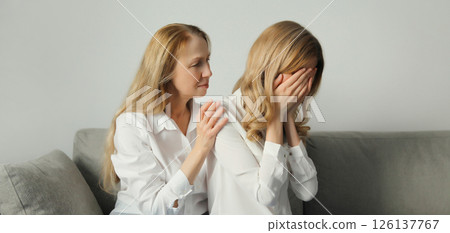 Upset offended caucasian two women, mature mother or sister and adult daughter together at home 126137767