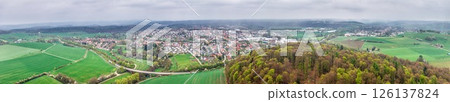 Aerial view of Bad Arolsen with residential area, fields and forest under cloudy sky 126137824