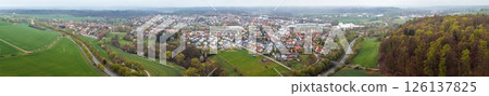 Aerial view of Bad Arolsen with residential area, fields and forest under cloudy sky Aerial view of Bad Arolsen with residential area, fields and forest under cloudy sky 126137825