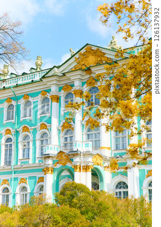the incredibly picturesque facade of the Winter Palace through the branches of trees on a clear spring day, the heritage of Russia, the most famous landmark of St. Petersburg, the museum 126137932