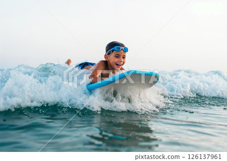 Young Boy Enjoying Bodyboarding in the Ocean on a Sunny Day During Summer 126137961