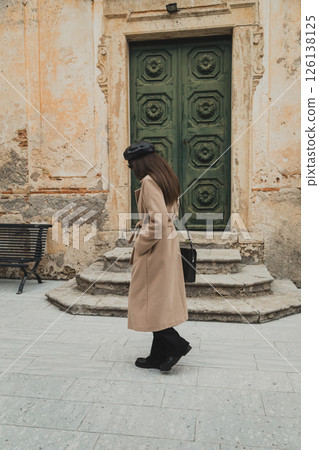 Woman In Vintage Clothing Sitting On The Bench Of The Old Town Woman In Vintage Clothing Sitting On The Bench Of The Old Town 126138125