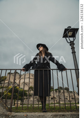 Elegant Model Posing On The Railing In The Medieval Italian Town Square Elegant Model Posing On The Railing In The Medieval Italian Town Square 126138132