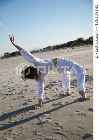 Blonde Girl With White Dress Dances On The Beach In Summer Near The Sea Blonde Girl With White Dress Dances On The Beach In Summer Near The Sea 126138143