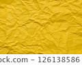 A textured yellow crumpled paper background with natural creases and folds. Ideal for design projects, digital graphics, or creative presentations requiring a vibrant 126138586