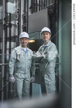 Two workers looking at the camera 126139446