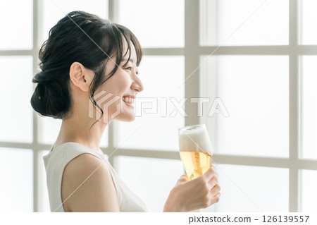 Asian woman having beer lunch at home (beer glass) Asian woman having beer lunch at home (beer glass) 126139557