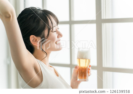 Asian woman having beer lunch at home (beer glass) Asian woman having beer lunch at home (beer glass) 126139558