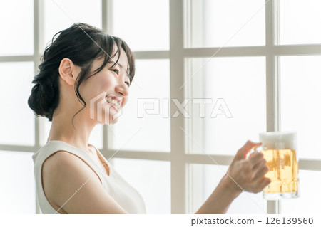 Asian woman drinking beer at home (beer mug) Asian woman drinking beer at home (beer mug) 126139560