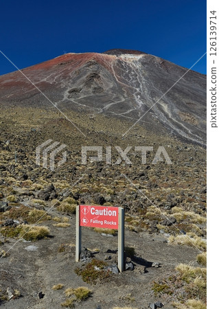 Caution sign board on mountain trail, falling rocks 126139714