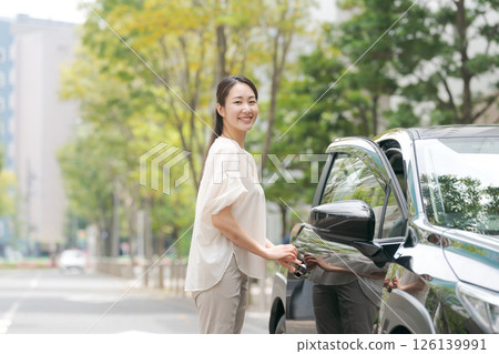 A young lady descending from the car 126139991