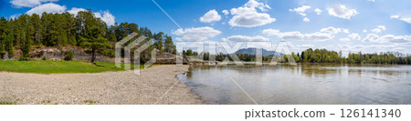 View of Love Stone over the Biya River with the town of Turochak on the opposite bank. Concept of serenity, connection, and sacred places in wild Russian nature View of Love Stone over the Biya River with the town of Turochak on the opposite bank. Concept of serenity, connection, and sacred places in wild Russian nature 126141340