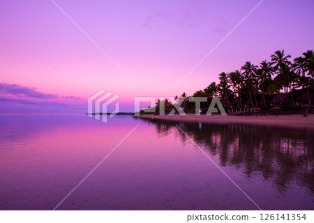 Oceania, Republic of Fiji, Viti Levu, Coral Coast, Korotogo, Sunrise on the beach and reflections on the sea 126141354