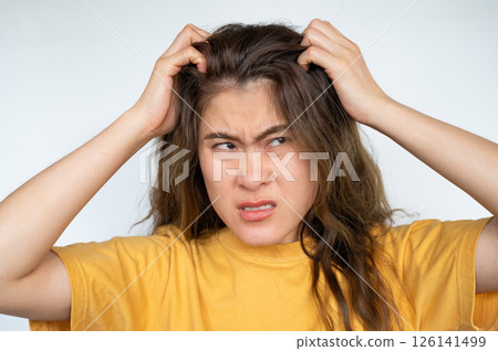 Asian woman scratching her scalp caused of itchy scalp. Dandruff and an inflammatory skin condition called seborrheic dermatitis are the most common causes of itchy scalp. Asian woman scratching her scalp caused of itchy scalp. Dandruff and an inflammatory skin condition called seborrheic dermatitis are the most common causes of itchy scalp. 126141499