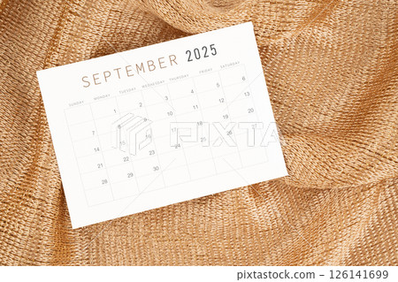 September 2025 calendar card on golden color textile. 126141699
