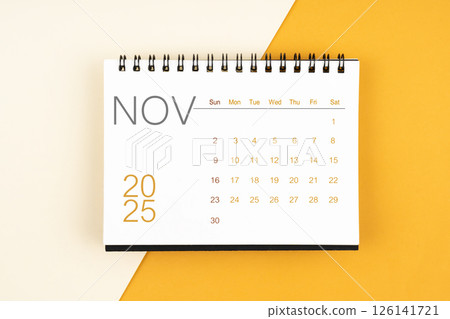 Desk calendar for November 2025 year on yellow background, Flat lay. 126141721