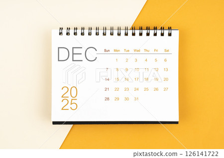 Desk calendar for December 2025 year on yellow background, Flat lay. Desk calendar for December 2025 year on yellow background, Flat lay. 126141722