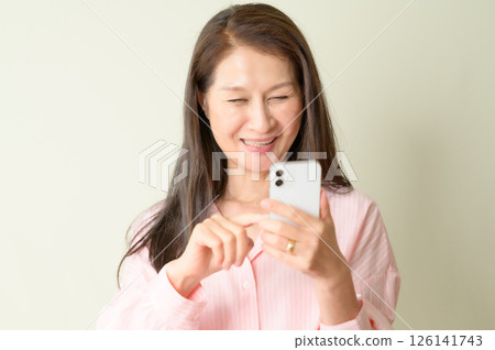 Senior woman operating a smartphone Senior woman operating a smartphone 126141743