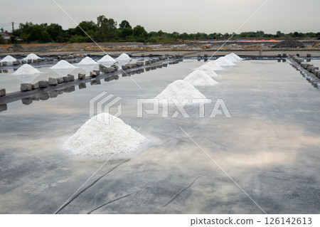 Salt mounds form in evaporation pools near Asian village using natural sun drying in rural area 126142613