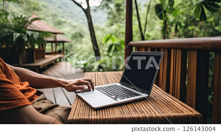 A man working in front of laptop monitor in cozy forest house. Hands close-up. Embracing the beauty of nature, a man immerses himself in work, surrounded by the peaceful ambiance of a forest house. A man working in front of laptop monitor in cozy forest house. Hands close-up. Embracing the beauty of nature, a man immerses himself in work, surrounded by the peaceful ambiance of a forest house. 126143004