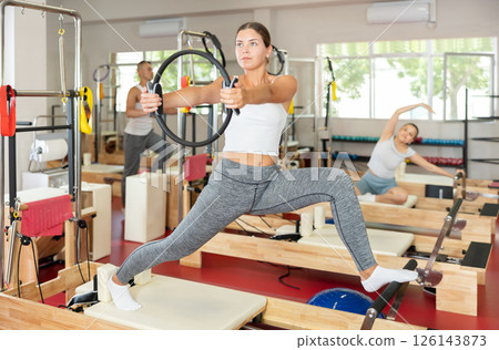 Young woman exercising with pilates ring Young woman exercising with pilates ring 126143873
