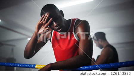 Man, boxer and tired with sweat in ring for training, fitness and fatigue with burnout, rest and low angle at gym. Person, athlete or fighter with combat sports, exhausted and break at exercise club Man, boxer and tired with sweat in ring for training, fitness and fatigue with burnout, rest and low angle at gym. Person, athlete or fighter with combat sports, exhausted and break at exercise club 126143883