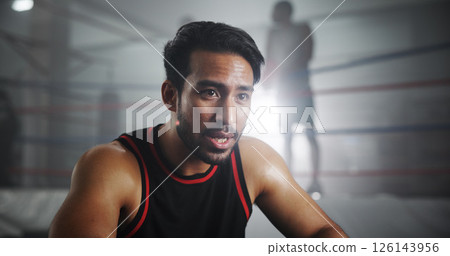 Man, boxer and tired with workout in gym, intense and recovery with sweating for self defense exercise. Serious, fatigue and rest with exhausted male athlete, fitness and endurance by boxing ring 126143956