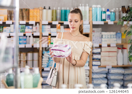 Young woman choosing pads in pharmacy Young woman choosing pads in pharmacy 126144045