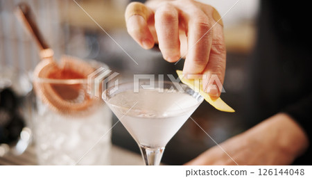 Cocktail, cafe and hands of barman with glass, lemon and tools for artisan beverage recipe. Mixology, small business pub and person at counter with happy hour drinks, martini process or craft alcohol 126144048