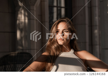 Woman Portrait Sunlight Window Light - Close-up portrait of a woman sitting in a chair, illuminated by sunlight streaming through a window. 126144168