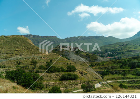 A mountain range with a small village in the valley 126144321