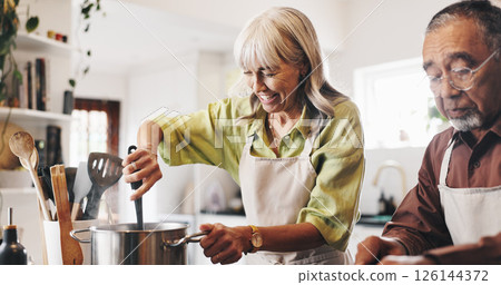 Happy, cooking and mature couple in kitchen in home with recipe for dinner, meal or dish. Bonding, pot and man with woman for preparing supper with health, wellness and nutrition in house together. 126144372