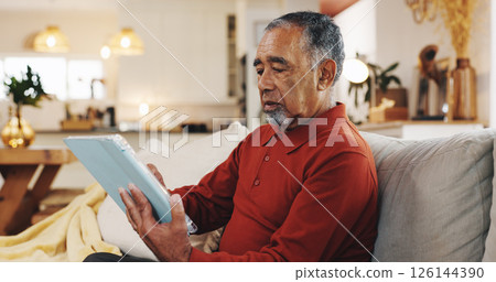 Senior man, tablet and thinking with living room, sofa and reading online news blog post. Relax, digital technology and mature person with app, internet scroll and social media at home for retirement Senior man, tablet and thinking with living room, sofa and reading online news blog post. Relax, digital technology and mature person with app, internet scroll and social media at home for retirement 126144390