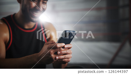 Hands, phone and texting at gym by boxing ring with notification for invite to global contest at training center. Person, athlete and fighter with smartphone, happy and chat at martial arts club 126144397