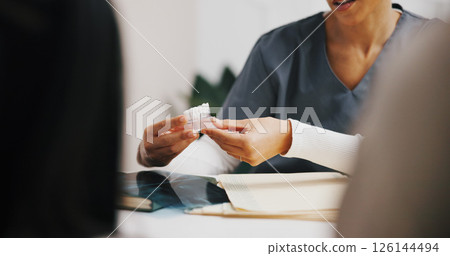 Hands, dentist and model in clinic consulting for oral hygiene, teeth whitening and cleaning checkup. People, discussion or orthodontist for tooth health, cavity or plaque removal procedure. Hands, dentist and model in clinic consulting for oral hygiene, teeth whitening and cleaning checkup. People, discussion or orthodontist for tooth health, cavity or plaque removal procedure. 126144494